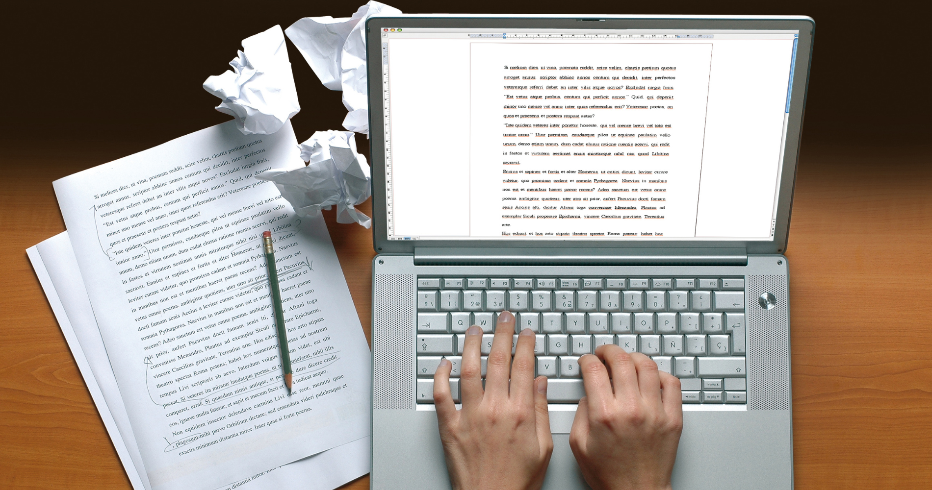 writer typing out article on laptop